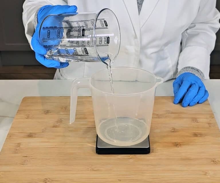 Distilled water is measured into a large plastic pitcher