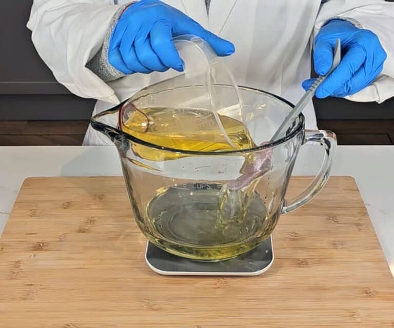 Olive oil is poured into our melted coconut oil and shea butter