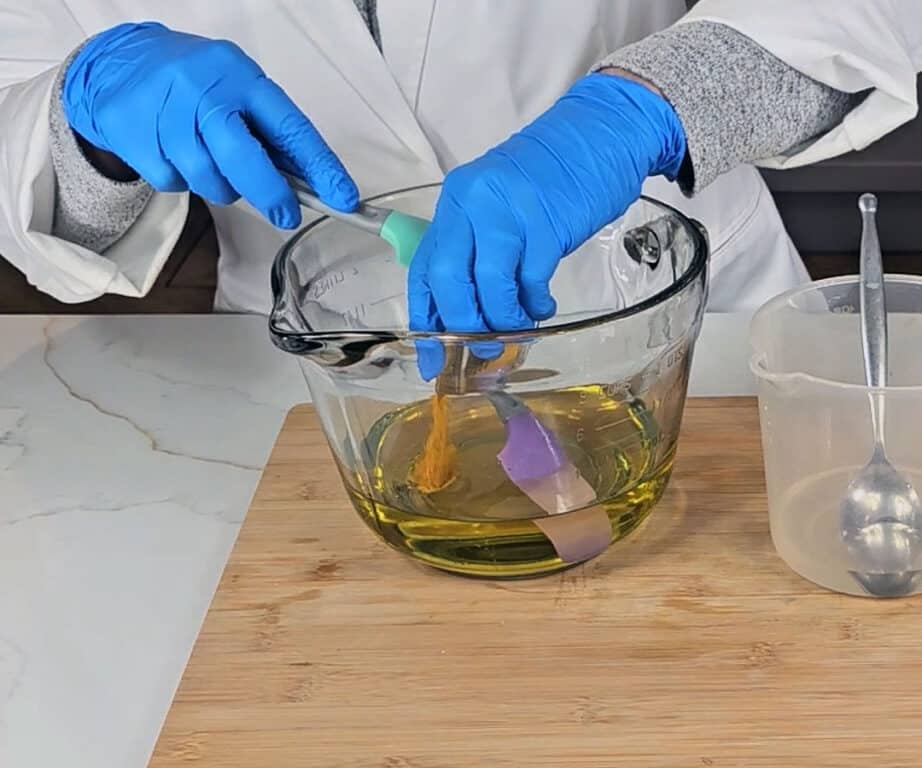 Turmeric is added to the melted oils