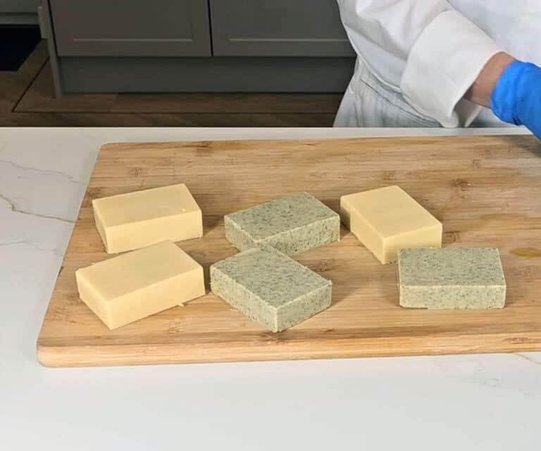 A set of castile soaps sit on a wooden board ready to cure for 4-6 weeks