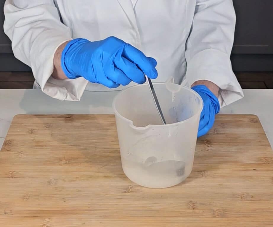 The sodium hydroxide and distilled water are stirred to create the lye solution