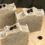Three bars of soap, with coffee beans surrounding it Three bars of soap, with coffee beans surrounding it