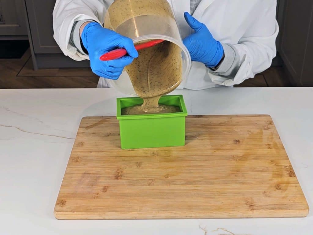The soap batter is poured into a silicon soap mold