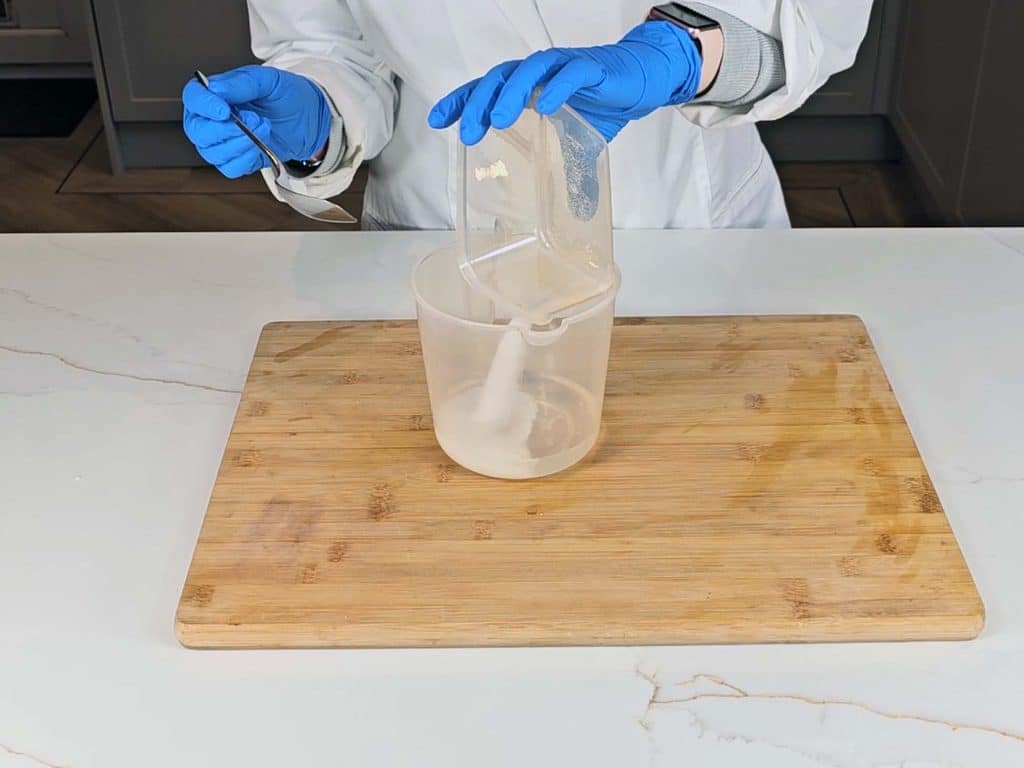 Sodium hydroxide is poured into distilled water to create liquid lye solution