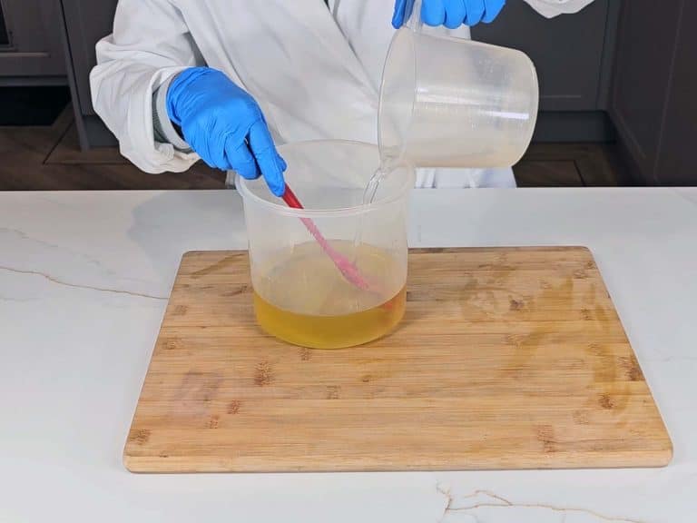 The lye solution is poured into our warmed oils to create soap batter