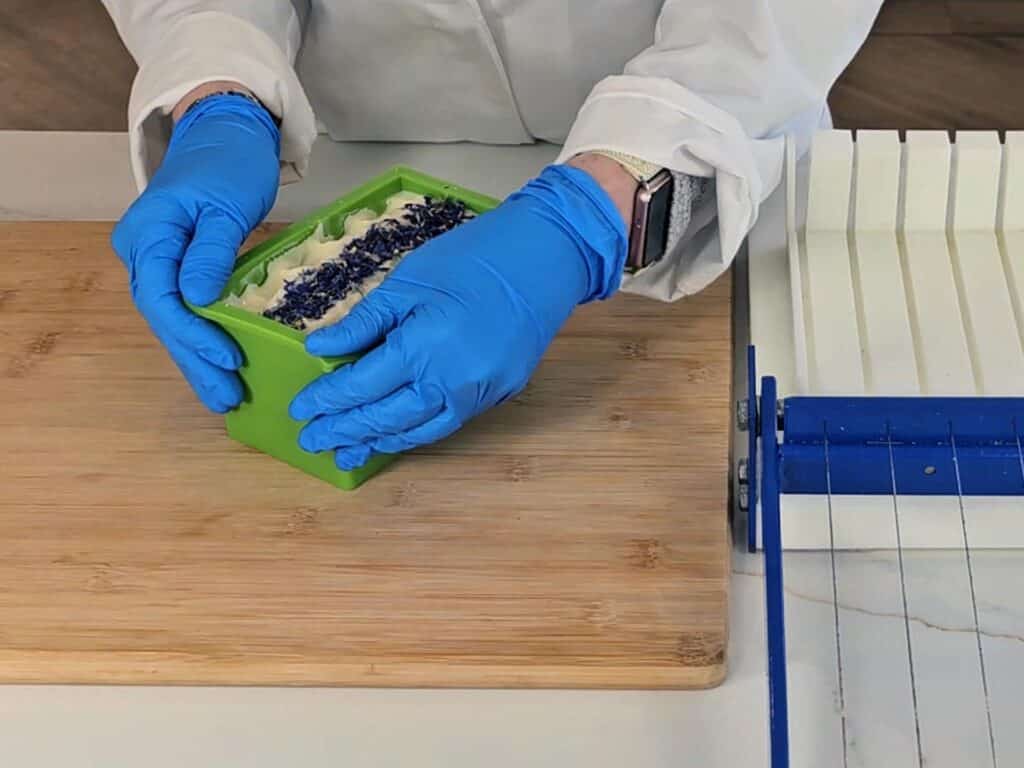 The hardened soap is being prepped to remove form the mold