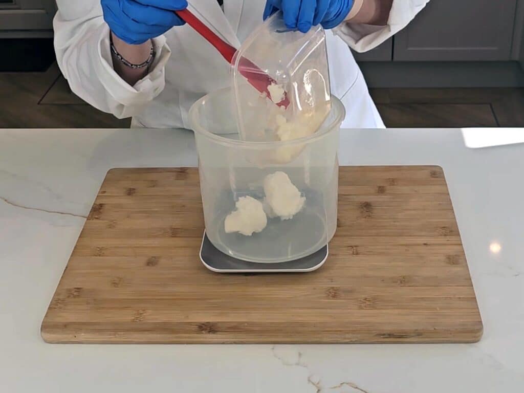 Coconut oil is measured into a PET plastic container