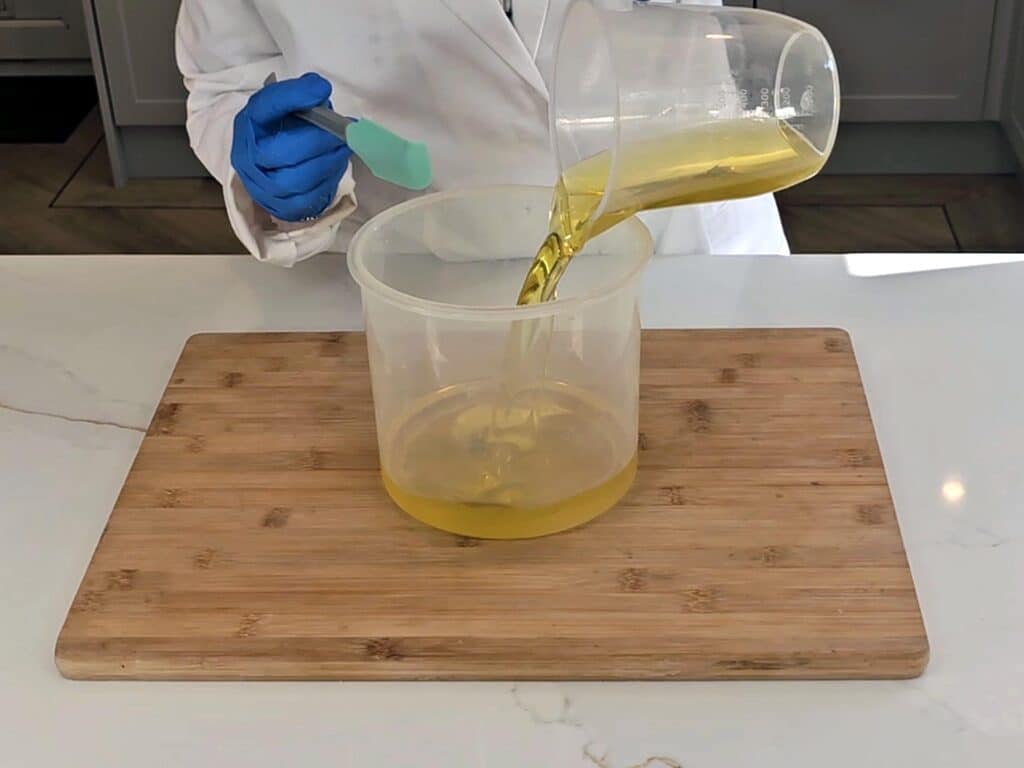 Olive oil is poured into a container of melted solid oils