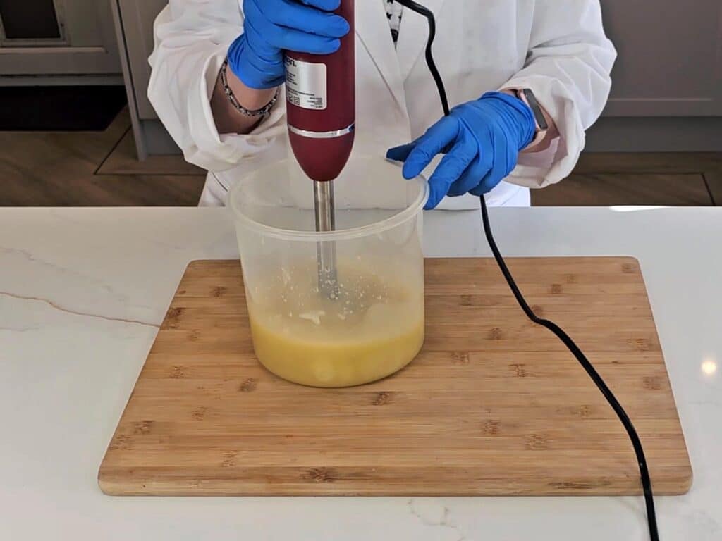 The emulsified soap batter is blended with a stick blender