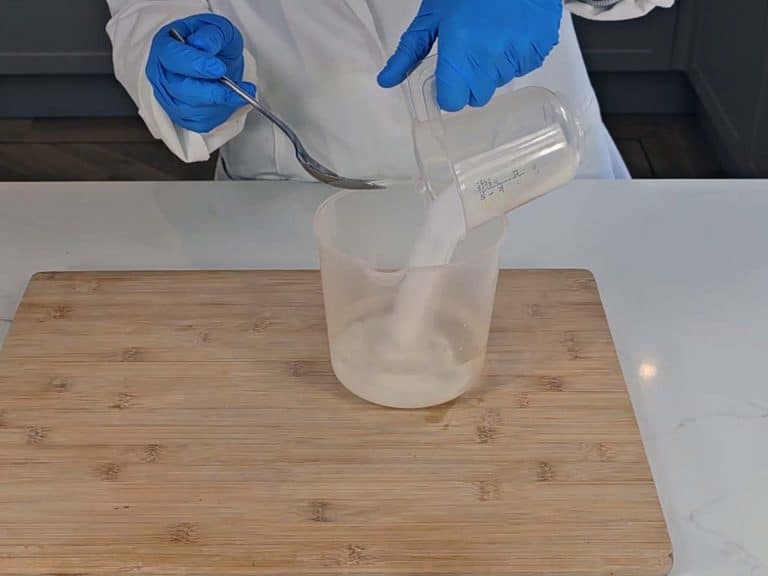 Lye crystals are poured into distilled water