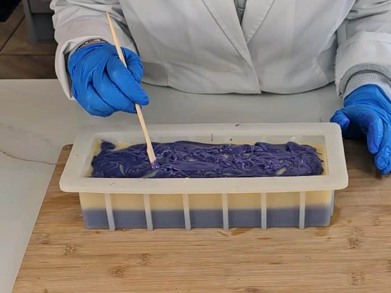 The surface of the soap is textured with a bamboo stirrer