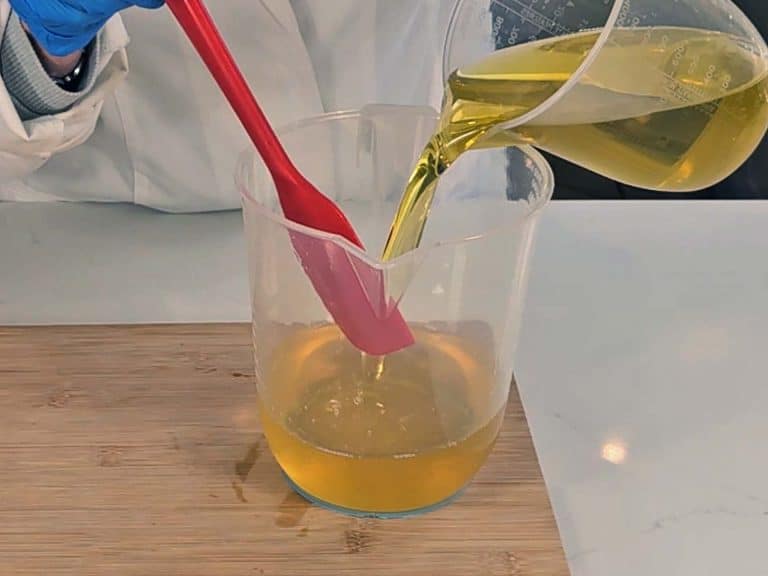 Olive oil is poured into the melted solid oils