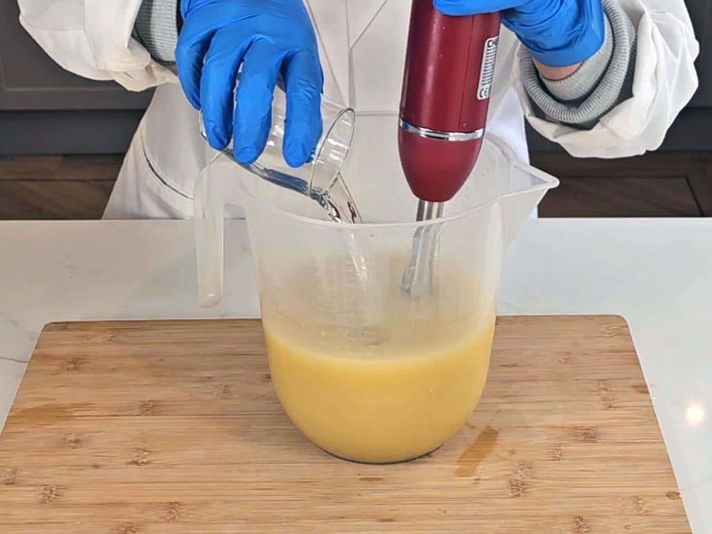 Essential oil is poured into the soap batter at trace Essential oil is poured into the soap batter at trace