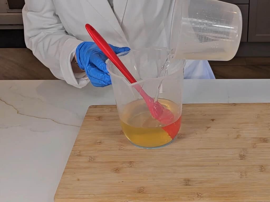 The liquid lye solution is poured into the melted coconut oil