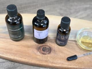 Best essential oils for skin sit next to a small bowl of oil and a pipette