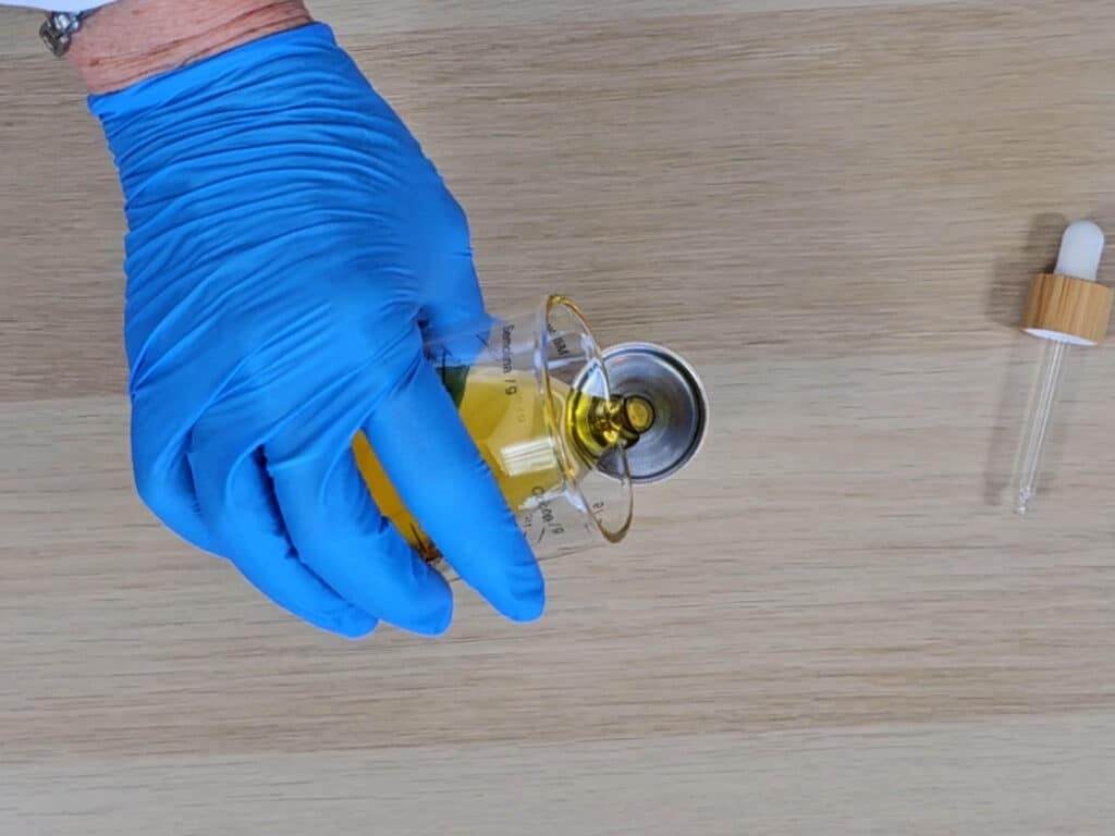 The finished cuticle oil is poured into a bottle to store