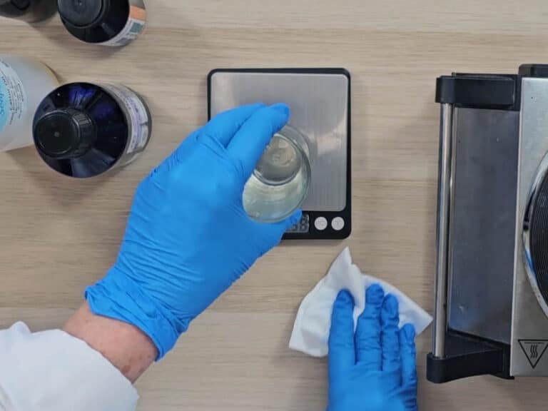 The melted coconut oil sits on a digital scale