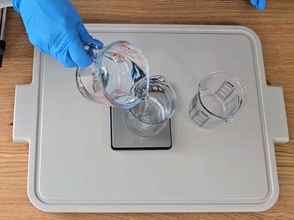 Weigh the distilled water into a heat safe beaker.