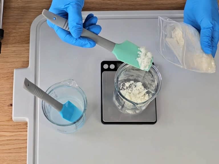 In a separate heat safe beaker, weigh the cocoa butter, emulsifying wax and the almond oil. Stir to combine. In a separate heat safe beaker, weigh the cocoa butter, emulsifying wax and the almond oil. Stir to combine.