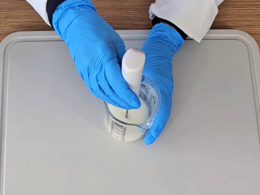 Use a mini mixer to blend the water and oil phases together.