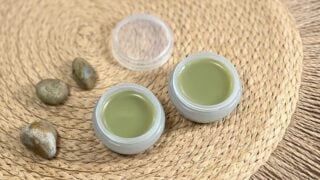 Two pots of diy cuticle balm sit together