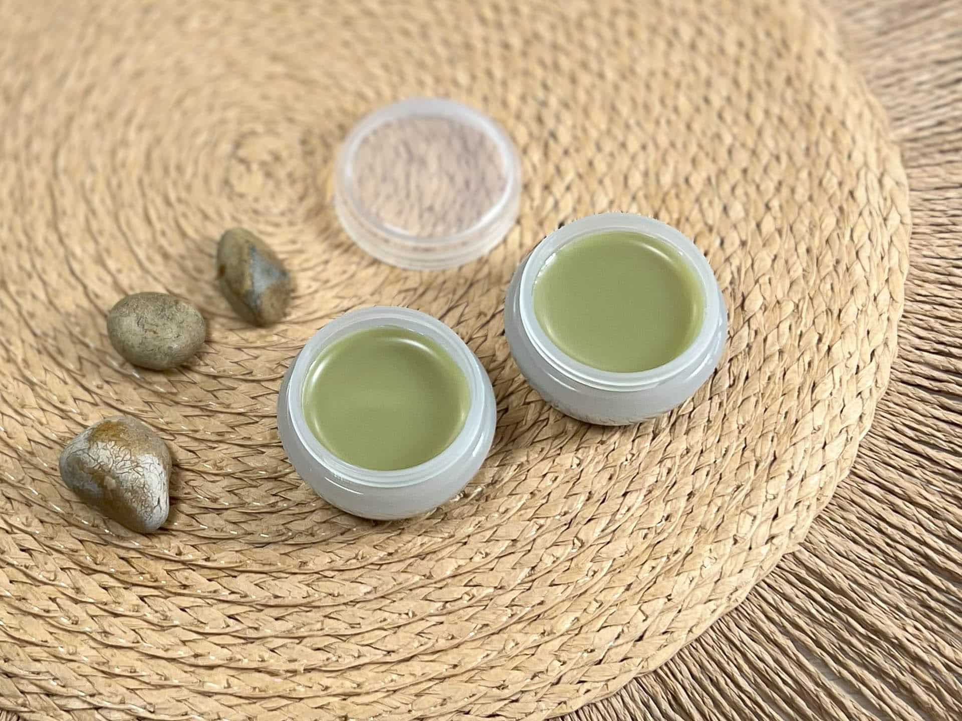 Two pots of DIY cuticle balm sit together Two pots of DIY cuticle balm sit together
