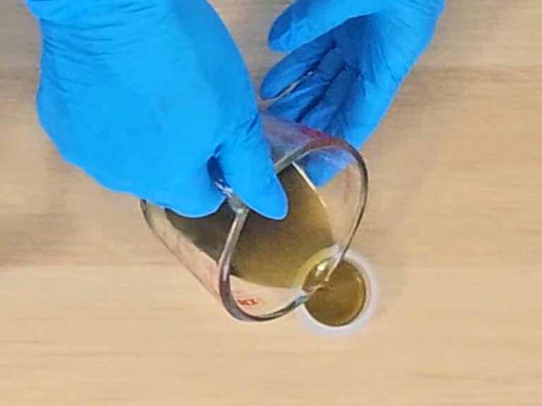 The mixture is poured into a small lip balm pot to store The mixture is poured into a small lip balm pot to store