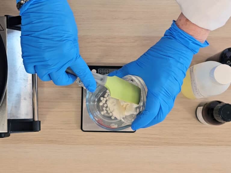 Butter and wax is measured in a heatproof beaker using a digital scale