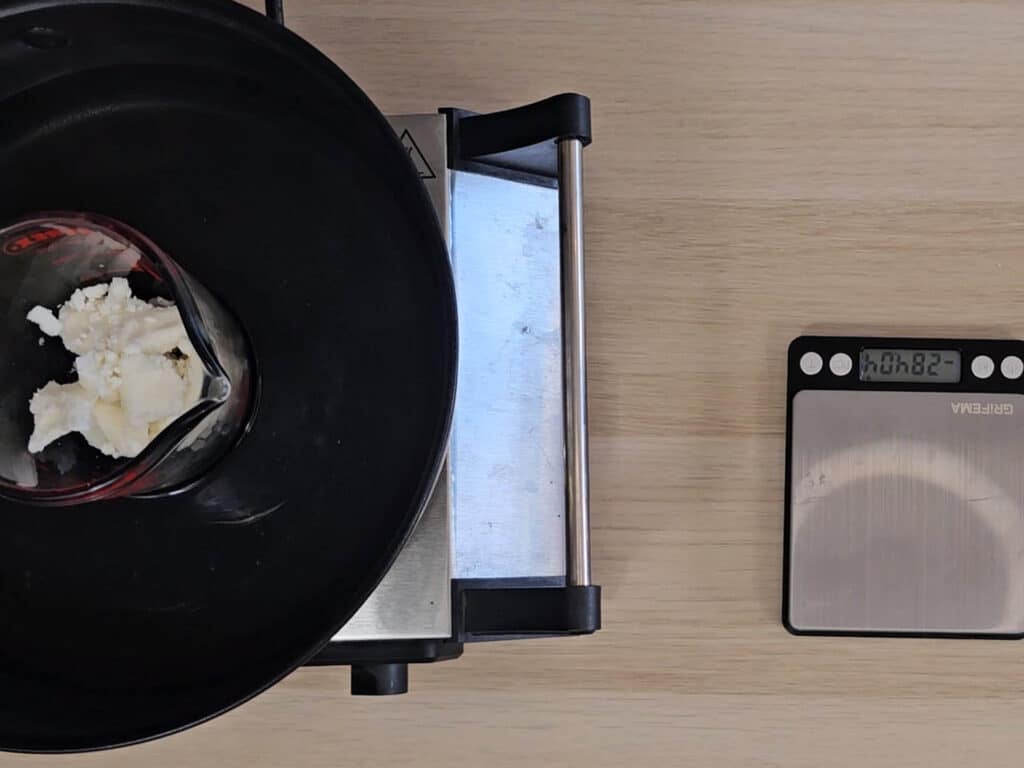 A heatproof beaker is placed in a waterbath to melt