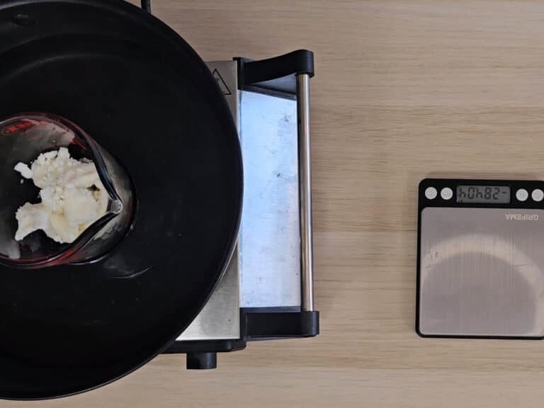 A heatproof beaker is placed in a waterbath to melt