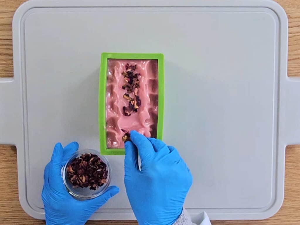 Dried rose petals are added to the surface of the soap Dried rose petals are added to the surface of the soap
