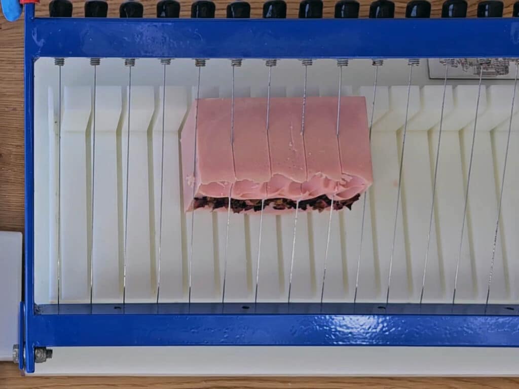 The soap is cut with a soap cutter