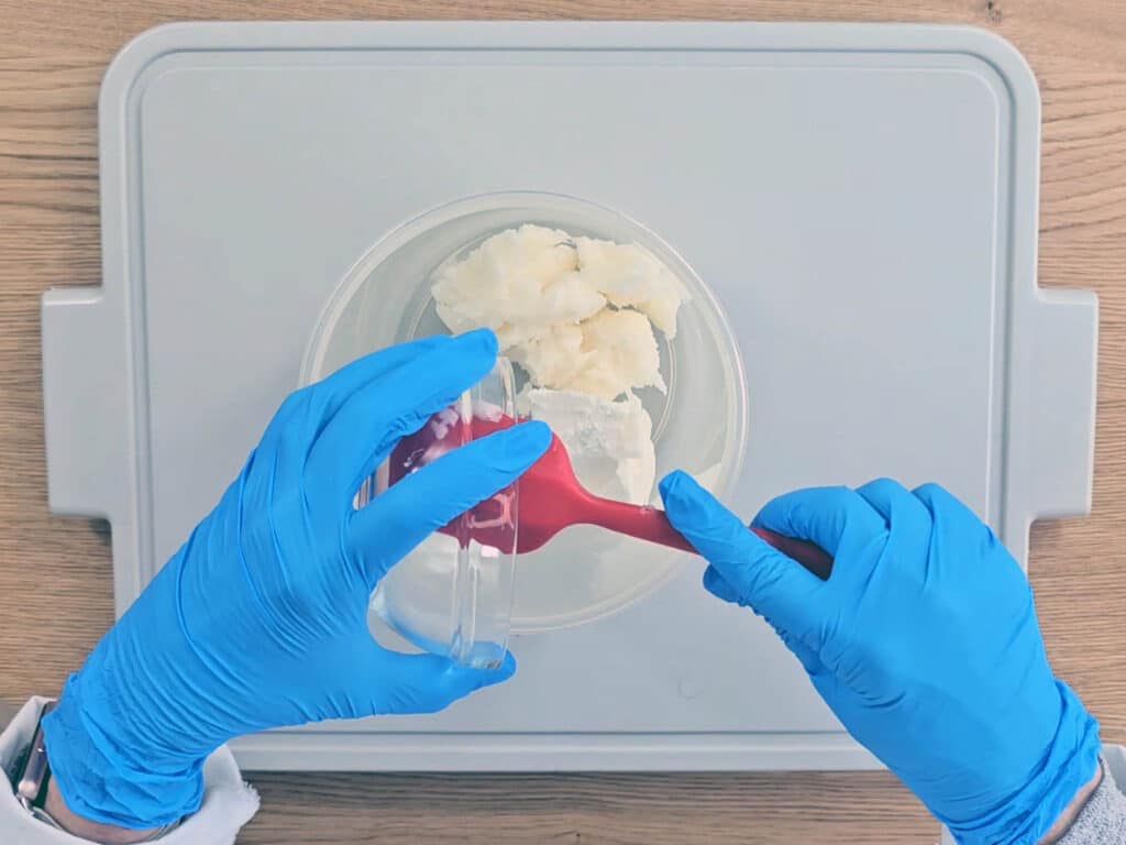 The solid oils are measured into a container