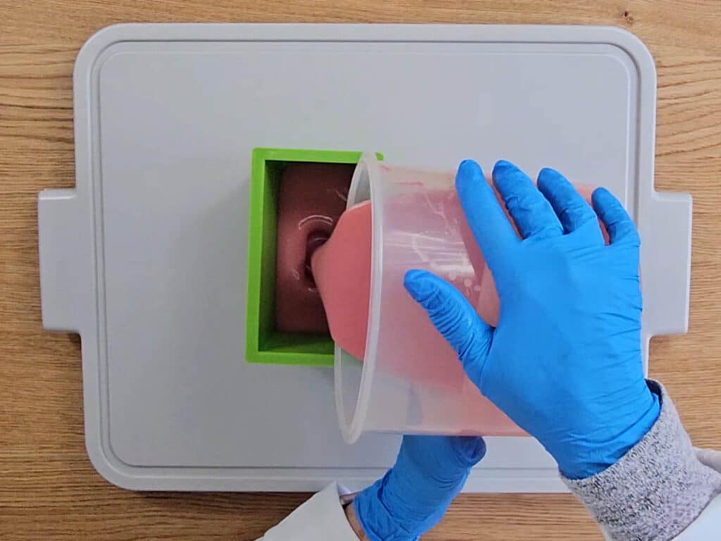 The soap batter is poured into a soap mold
