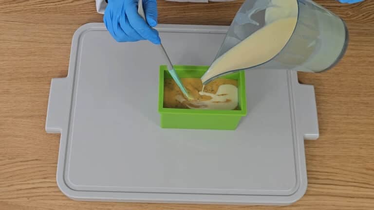 pour around ¾ of the white layer onto the first layer, mixing it in with the stirrer to create an uneven look when it's cut. pour around ¾ of the white layer onto the first layer, mixing it in with the stirrer to create an uneven look when it's cut.