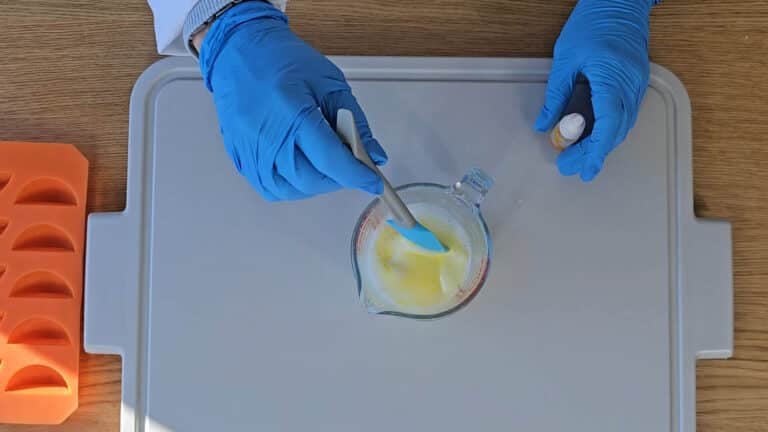 Once melted, add a few drops of yellow food coloring and carefully stir Once melted, add a few drops of yellow food coloring and carefully stir