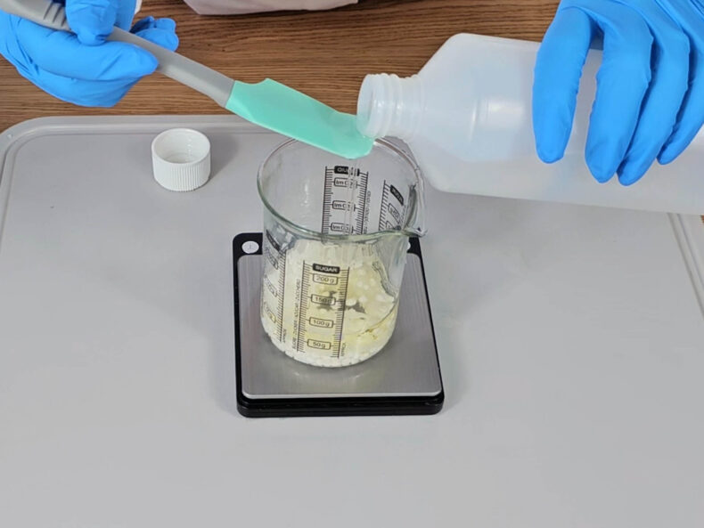 Add the fractionated coconut oil to the beaker.