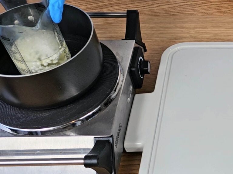 Place the beaker with the oils into a pan of simmering water Place the beaker with the oils into a pan of simmering water
