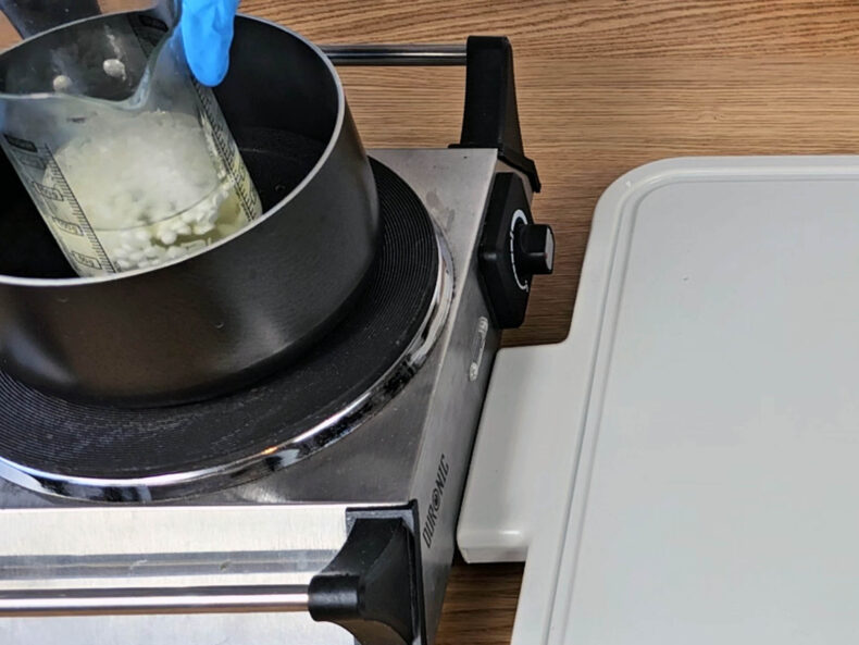 Place the beaker with the oils into a pan of simmering water