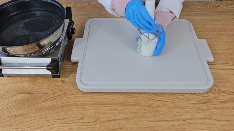 Using a mini blender begin to blend the water and oils together.