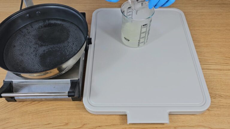 pour the beaker holding the melted oil and butter into the beaker holding the water pour the beaker holding the melted oil and butter into the beaker holding the water