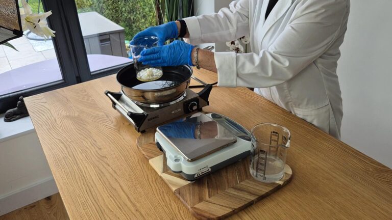 Place both the beakers into a hot water bath