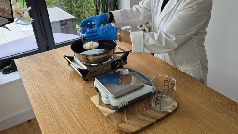 Place both the beakers into a hot water bath