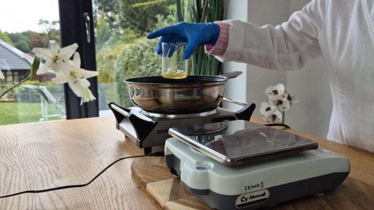 Stand the container or beaker containing the oils in a shallow saucepan with a couple of inches of water Stand the container or beaker containing the oils in a shallow saucepan with a couple of inches of water