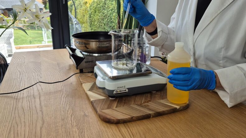 In a separate heatproof beaker, weigh the oils.
