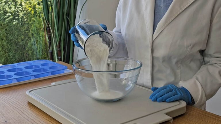 Pouring baking soda into a glass bowl to make DIY shower steamers Pouring baking soda into a glass bowl to make DIY shower steamers