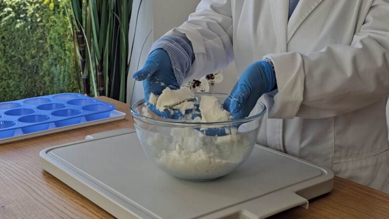 Mixing the shower steamer ingredients by hand until they resemble damp sand Mixing the shower steamer ingredients by hand until they resemble damp sand