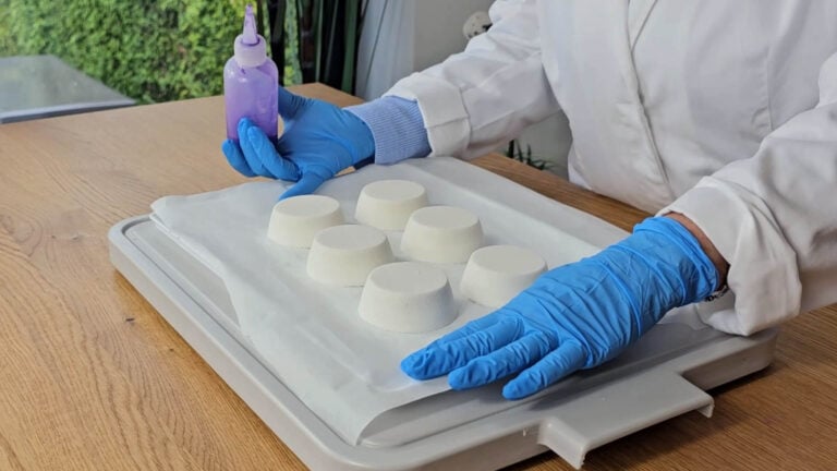 Arranging dried shower steamers on baking parchment before adding the mica decoration Arranging dried shower steamers on baking parchment before adding the mica decoration